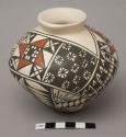 White jar with black and red design; signature T- - - sol  - - - uez