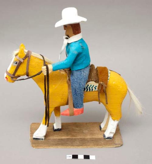 Folk art horse and rider on plywood base; signed on bottom "Phillip Cleveland"