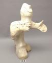 Standing human figure carved from whalebone; "Pinhead man"