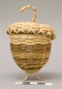Strawberry-shaped basket with lid; standing on three ash splint feet; signed Caron Shay '96 on the inside