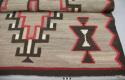 Navajo rug with central diamond design, gray background, black, red and white wool