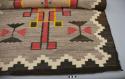 Navajo rug with geometric design, zigzag edges; gray, black, red, ochre and white wool