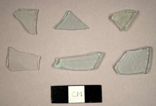 Colorless glass fragments, some flat and some curved