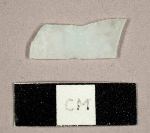 Colorless flat glass fragment, possibly frosted