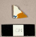 Hand painted creamware sherd with orange and blue decoration