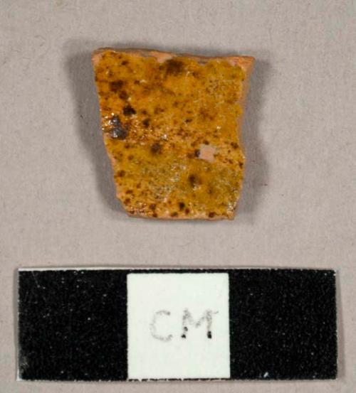 Yellow and brown mottled lead glazed earthenware sherd