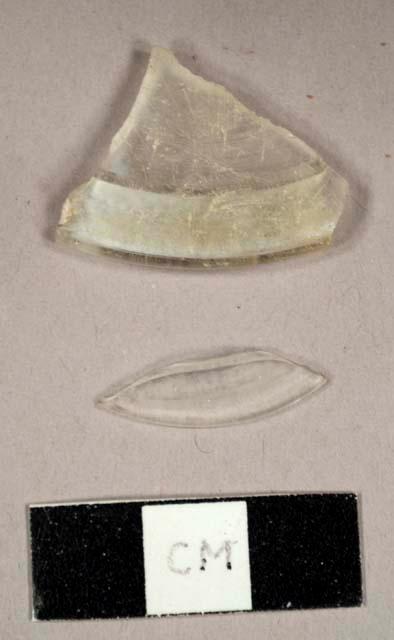 Colorless glass fragments, including one folded base for stemware vessel