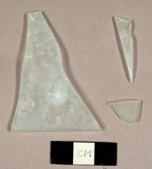 Colorless flat glass fragments, possibly frosted