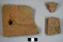 Brick roofing tile fragments, including one with nail hole