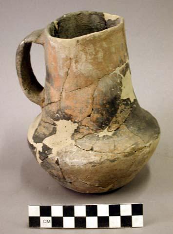 Ceramic complete pitcher, 1 handle, brown on orange exterior, reconstructed