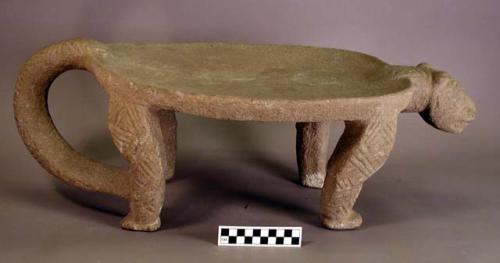 Stone metate with feline legs, head, tail