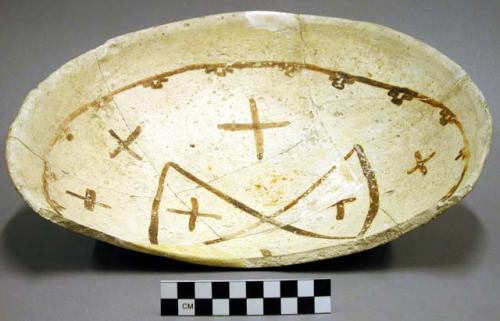 Ceramic partial bowl, black on yellow interior, mended