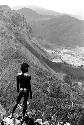 Samuel Putnam negatives, New Guinea; boy standing on a mound of rocks; Solimo stretching out below him