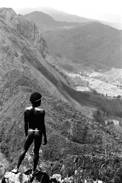 Samuel Putnam negatives, New Guinea; boy standing on a mound of rocks; Solimo stretching out below him