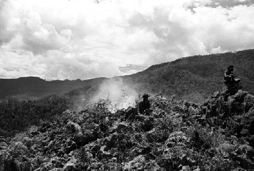 Samuel Putnam negatives, New Guinea; 2 people on a ridge to the southeast of the WW territory