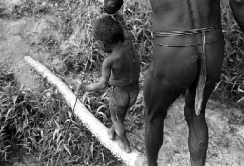 Samuel Putnam negatives, New Guinea; a little boy and a man crossing a foot bridge across a garden ditch