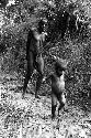 Samuel Putnam negatives, New Guinea; Haliole and little boy coming along very muddy path near Apulek