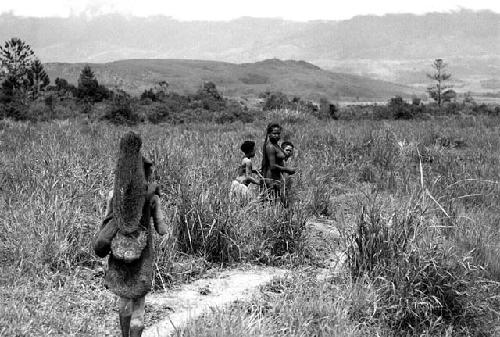 Samuel Putnam negatives, New Guinea; women going on their way to Etai; have stopped to put on clay