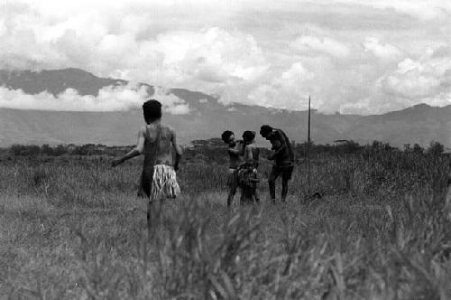 Samuel Putnam negatives, New Guinea; women going on their way to Etai; have stopped to put on clay