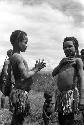 Samuel Putnam negatives, New Guinea; 2 little girls putting clay on; one looks at the camera