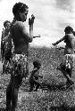 Samuel Putnam negatives, New Guinea; 2 little girls putting clay on; one looks at the camera