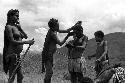 Samuel Putnam negatives, New Guinea; women and girls putting on clay; Yoli in the picture