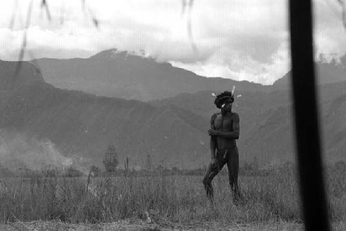 Samuel Putnam negatives, New Guinea; Walimo walking in the fields; shot from under an olea