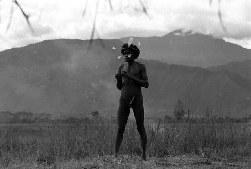 Samuel Putnam negatives, New Guinea; full length of Walimo; northeastern mt. wall behind him