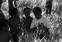 Samuel Putnam negatives, New Guinea; Etai; little boys including Uwar surround another little boy in a white shirt and blue pants