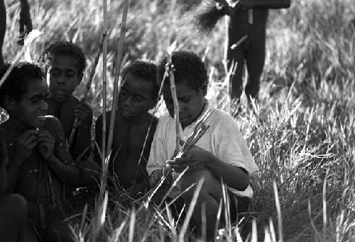 Samuel Putnam negatives, New Guinea; Etai; little boys including Uwar surround another little boy in a white shirt and blue pants