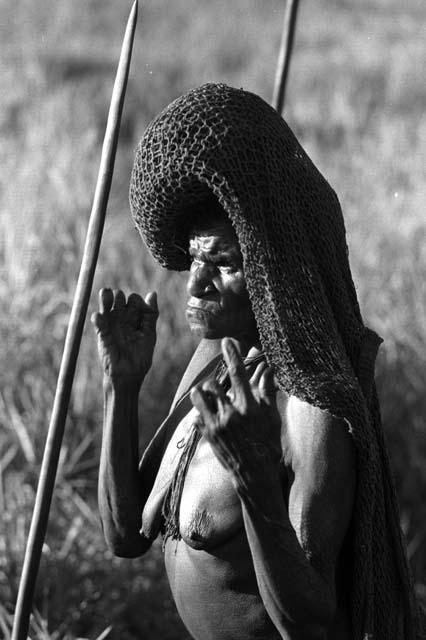 Samuel Putnam negatives, New Guinea; a woman dances on the Liberek; an old woman with a net on her head with joints missing from her fingers