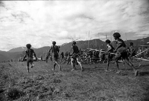 Samuel Putnam negatives, New Guinea; men running and dancing Etai on the Liberek