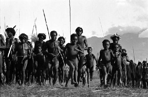 Samuel Putnam negatives, New Guinea; low angle of men running towards the camera