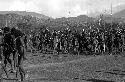 Samuel Putnam negatives, New Guinea; woman with mud clay on- around her are alot of little boys