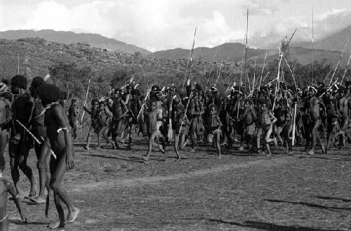 Samuel Putnam negatives, New Guinea; woman with mud clay on- around her are alot of little boys