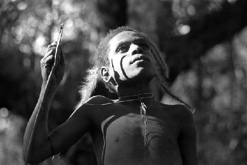 Samuel Putnam negatives, New Guinea; Okal; portrait with just feathery weeds hanging from his hair head and shoulders