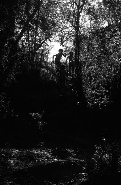 Samuel Putnam negatives, New Guinea; Isile and Okal join other boys and they dash out from the bed of the Elokhere River and up the path