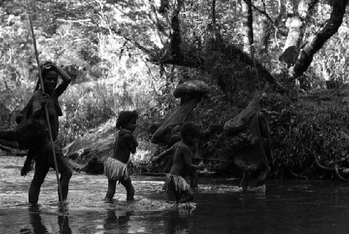Samuel Putnam negatives, New Guinea; women and children crossing the Elokhere River