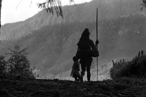 Samuel Putnam negatives, New Guinea; woman and child; silhouette- walking out onto the lighter part near the woods that go down to the Elokhere