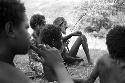 Samuel Putnam negatives, New Guinea; Children on the Anelerak for an Etai; one of the boys in the group has a small bug; he holds it in the air