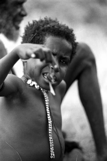 Samuel Putnam negatives, New Guinea; Milika's son with the bug in hand