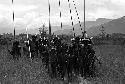 Samuel Putnam negatives, New Guinea; group of people going to the Etai; about 20 boys and men and spears