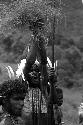 Samuel Putnam negatives, New Guinea; three men dancing; one man singing; holding up two grass tassels in the air