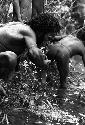 Samuel Putnam negatives, New Guinea; man drinking from the Aikhe