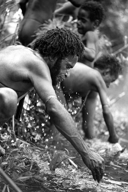 Samuel Putnam negatives, New Guinea; man drinking from the Aikhe