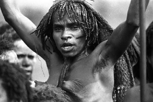 Samuel Putnam negatives, New Guinea; head of a woman; arms upraised; dancing