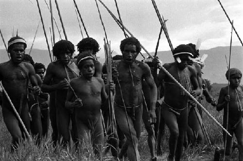 Samuel Putnam negatives, New Guinea; a men's group coming toward the Liberek