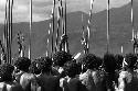 Samuel Putnam negatives, New Guinea; from behind men's group, head and shoulders and spears