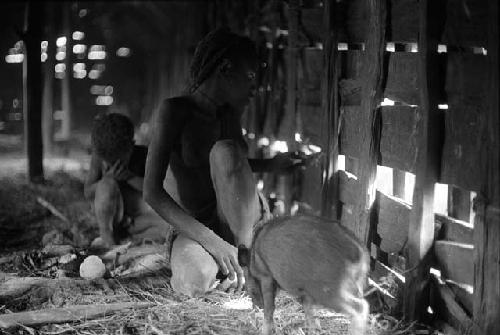 Samuel Putnam negatives, New Guinea; pig and woman and child inside of a hunu