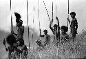 Samuel Putnam negatives, New Guinea; men jirring in the end of the Warabara a the Wittaia